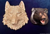 Front view of both plaques showing wolf and bear heads