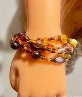 Full view of coiled bracelet on wrist form showing bead colors and arrangement