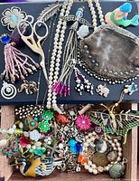 Overview of trinkets on black surface and drawer