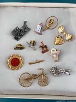 Front view of all eleven pins and brooches