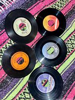 Five of the six records laid out showing label designs