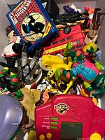 Top view of shoebox showing handheld game, Spider-Man pack, London bus, various action figures and accessories