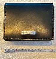 Front view of black leather ST Dupont card case with ruler for scale