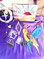 Group shot of all eight sun catchers on purple cloth