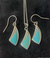 Necklace and two matching earrings showing turquoise in sterling silver setting