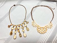 Both necklaces laid flat showing overall design and scale