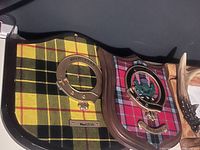 MacLeod plaque close-up showing tartan, crest ring and nameplate