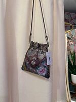 Front view of hand-painted leather crossbody bag