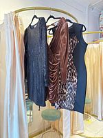 All three dresses hanging on rack