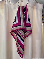 Pink, tan, black and white chevron stripe scarf hanging