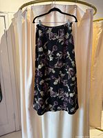 Black floral skirt on hanger