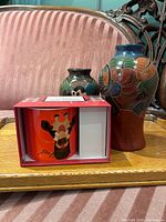 Front view of both incised pottery vases showing decoration and shapes