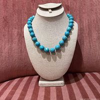 Necklace displayed on bust showing bead size, color and overall appearance