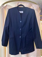 Navy collarless blazer with three buttons and Origins label