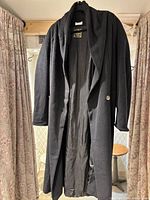 Front view showing length, shawl collar, single button, and lining