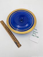Full view of cobalt blue cake plate beside 12-in. ruler and note card