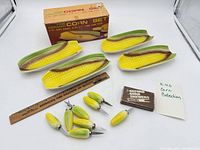 Full lot showing four dishes, eight skewers, box, leaflet