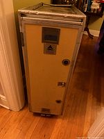 Front view of Delta beverage cart showing tan door, vents, latches, Delta badge