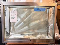 Front view of glass display cabinet showing metal frame and overall size