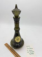 Full view of green Jim Beam decanter with stopper and label