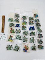 Overview of all bagged marbles with ruler for scale