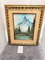 Overall view of framed mountain landscape painting