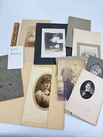 Group shot showing majority of mounted photographs layered on table