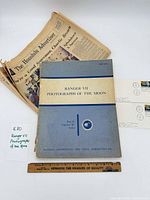 Book cover, newspaper, two covers in layout