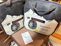 Front view of two carry cases showing TireChain.com branding