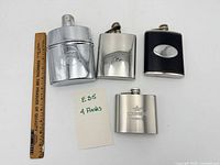 All four flasks with ruler for scale