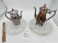 Both coffee pots and both trays displayed