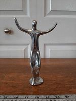 Front view of Hoselton polished aluminum figure showing form and finish
