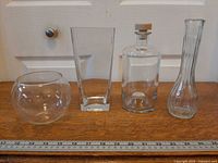 All four clear glass items aligned with ruler for scale