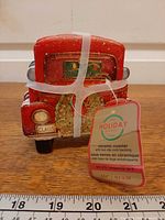 Front view showing red truck design and hang tag