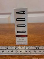 Front of sealed Goda perfume box with ruler for scale