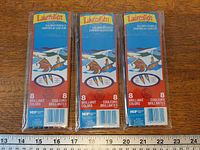 Front view of three sealed Laurentien colored pencil packs