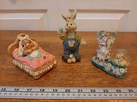 All three figurines with ruler for scale