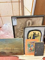 All six artworks grouped: framed back, seascape, oval board piece, small mat piece, metal block