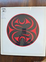 Full view of mounted circular salmon motif print with numbering and signature visible