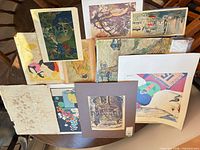 Group shot of all prints standing on chair showing variety of sizes, colours and mounting