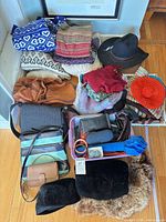 Group shot of all clothing, hats, bags, scarves and accessories arranged on floor