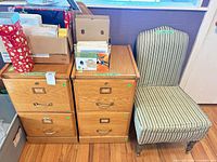 Front view of both oak lateral cabinets and striped slipper chair