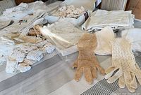 Overall lot showing linens, trims and two pairs gloves