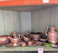Overall lot on shelf showing majority of silverplate pieces