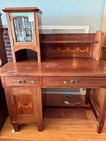 Front view of desk with hutch showing drawers, cabinet door, inlay