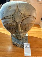 Front view of soapstone head on base showing drilled dot decoration