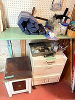 Wood side cabinet, three-drawer rolling cabinet, assortment of tools and hardware on shelf