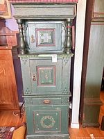 full view of tall painted cabinet showing doors, drawer, and finish