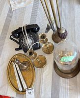 Overview of entire lot showing telephone, candlesticks, tray, candles, fireplace tools, glass dome clock