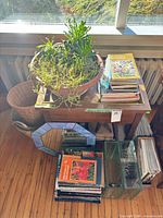 Overall lot showing table, planter, books, mirror, glass vases, basket, magazines